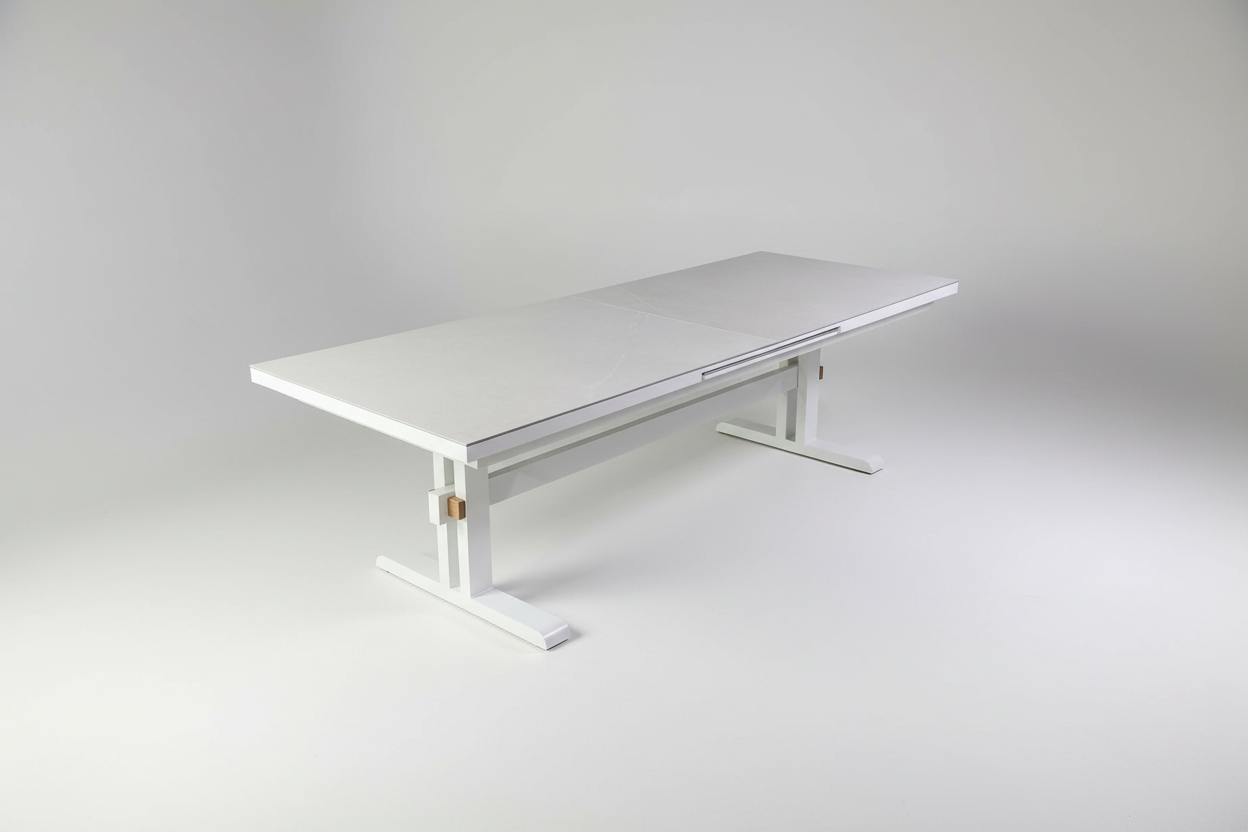White adjustable height table on a white background